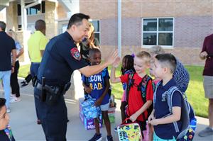 Chief Gaw greeting Robertson Elementary Students on the First Day of School.